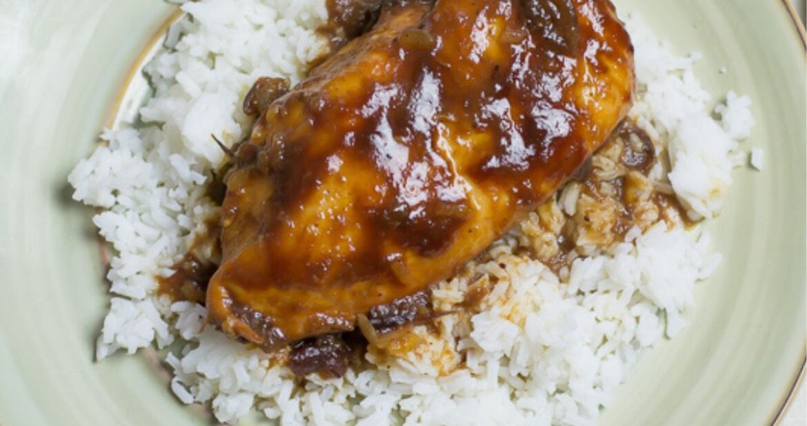 Crock Pot Boneless chicken cooked in cranberry and bbq sauce on a plate.