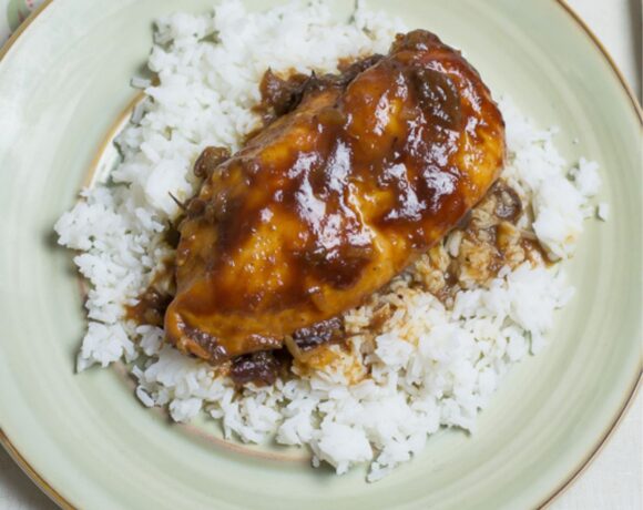 Crock Pot Boneless chicken cooked in cranberry and bbq sauce on a plate.