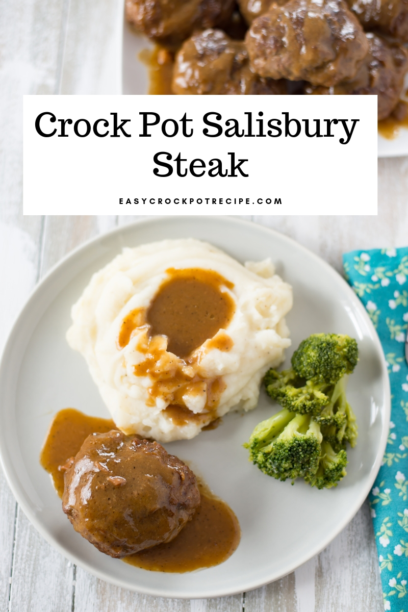A grey plate with a serving of Crock Pot Salisbury Steak with mashed potatoes and brocolli