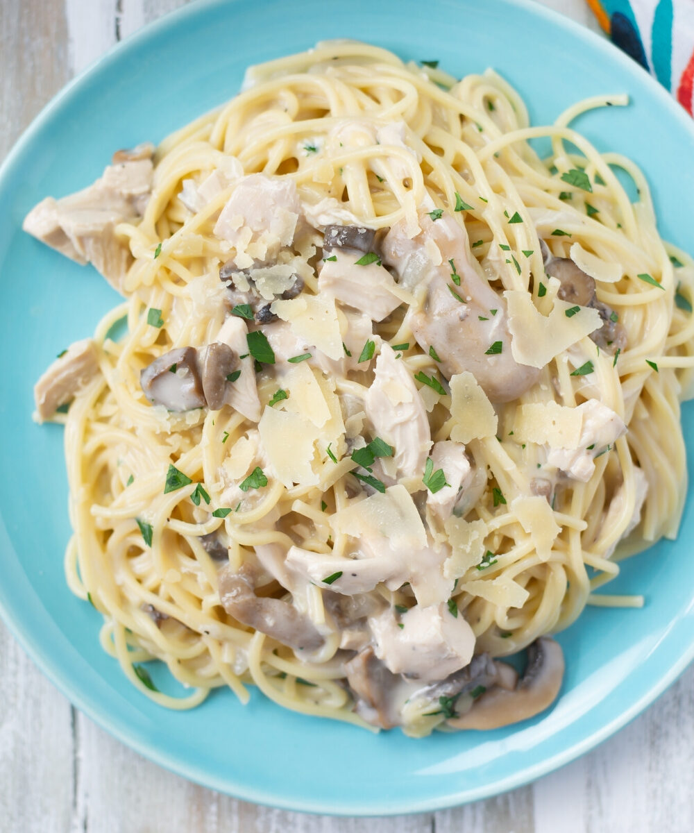 A blue plate with a serving of Crock Pot Chicken Tetrazzini