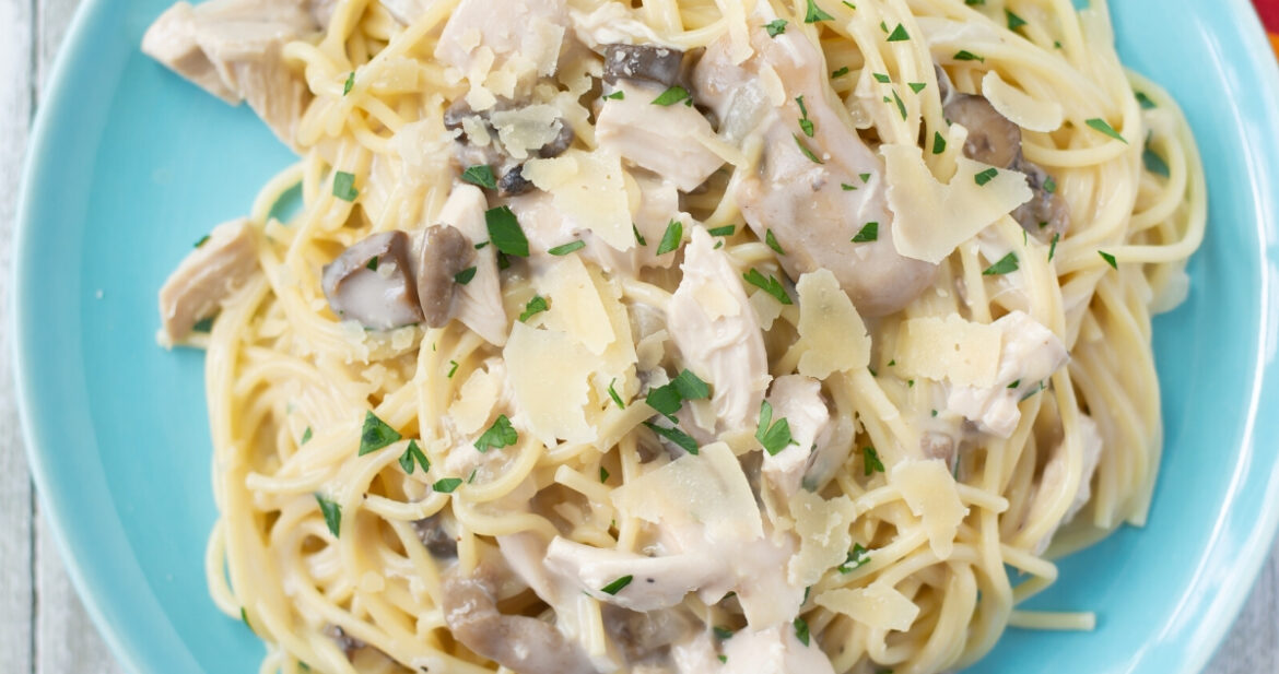 A blue plate with a serving of Crock Pot Chicken Tetrazzini