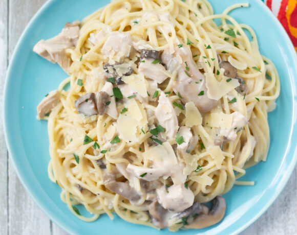 A blue plate with a serving of Crock Pot Chicken Tetrazzini