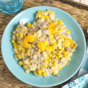 A serving Crock Pot Cowboy Casserole in a blue bowl.