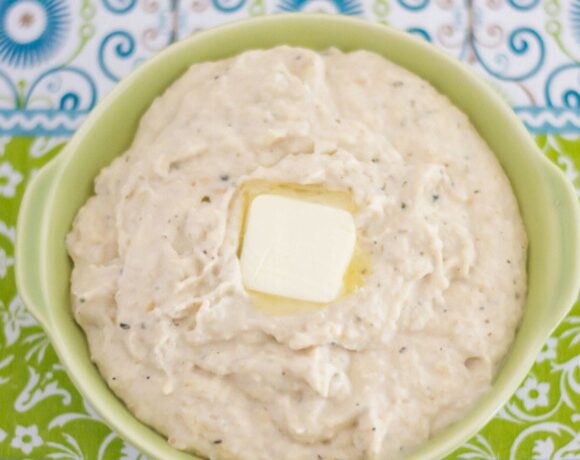 A serving bowl with Ranch Mashed Cauliflower on a table.