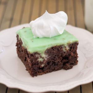 Square piece of Pistachio Poke Cake on a plate.