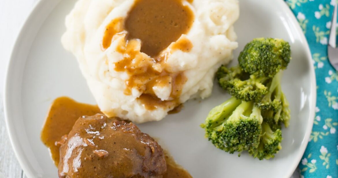 Salisbury Steak served with mashed potatoes and gravy.