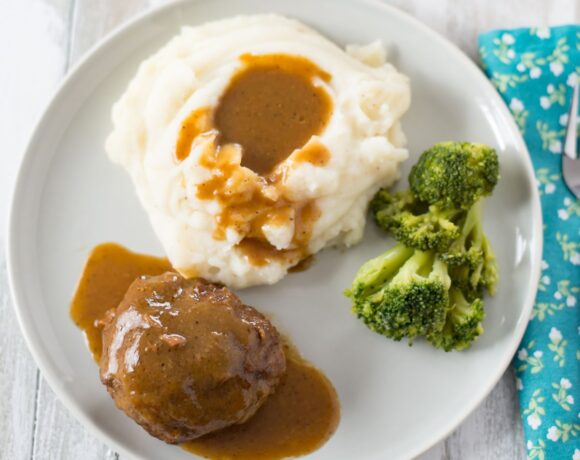 Salisbury Steak served with mashed potatoes and gravy.